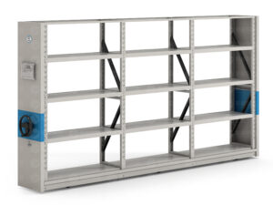 Light grey manual compact racking system with reinforced shelf panels, featuring three-spoke hand crank on blue accent strip, adjustable shelf heights with perforated uprights, and diagonal bracing for heavy-duty storage in archives and warehouses.